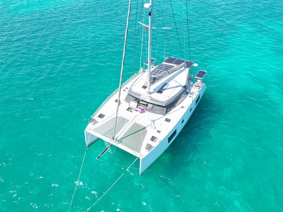 Aerial view of Courage anchored in turquoise water