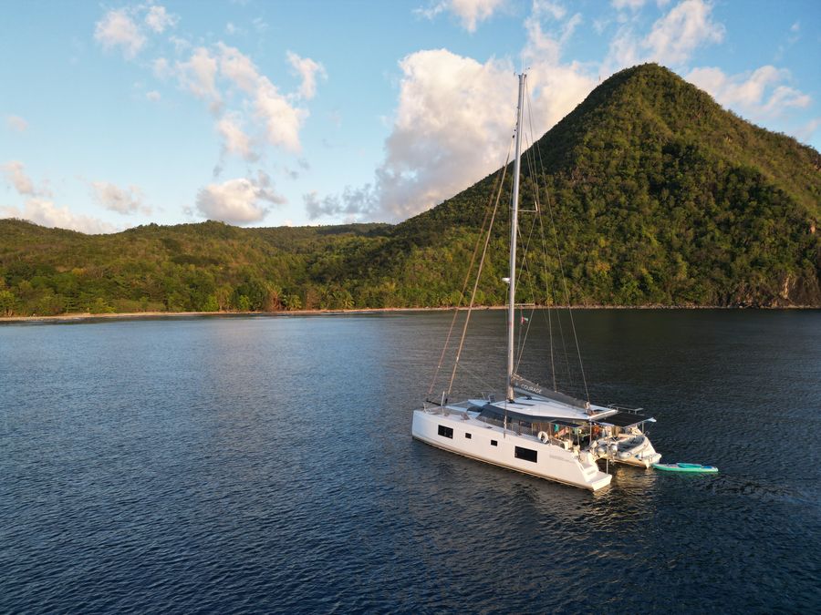 Aerial view of Courage anchored below a green hillside