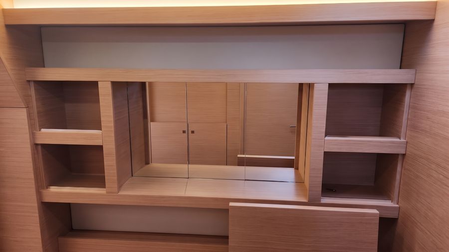 Open shelving and desk storage in the master cabin