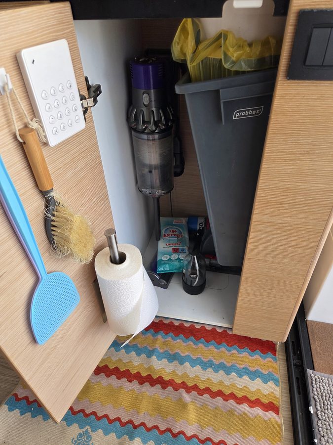 Galley utility locker with vacuum and storage bin